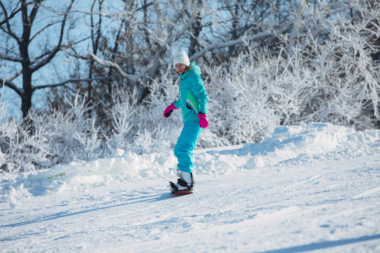 Winter sport activity, woman snowboarder riding