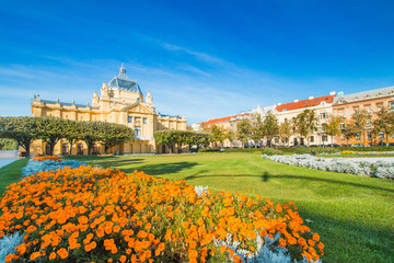     Colorful Zagreb, Croatia, art pavilion and beautiful flowers in park in summer day, classic 19...
