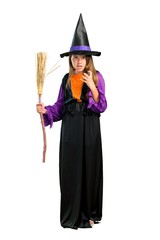 A full-length shot of a Little girl dressed as a witch for halloween holidays annoyed angry in furious gesture isolated on white