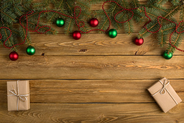 Spruce gift, branches and ornaments on the table. Procurement, Christmas composition, top view,...