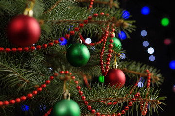 Christmas tree, on the table, against the background of blurry lights, bokeh. The concept of New Year.