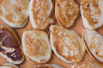 Small pancakes on wooden table background