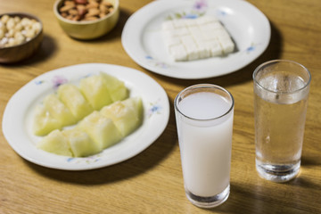 Turkish raki with melon cookies on wooden table