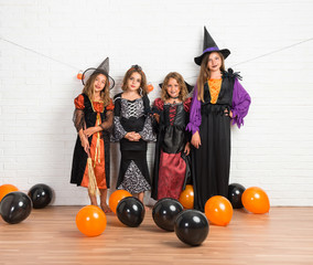 Group of friends with costumes of vampires and witches for halloween holidays