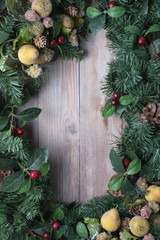 Christmas background with greenery glittery pear ornaments and red berries