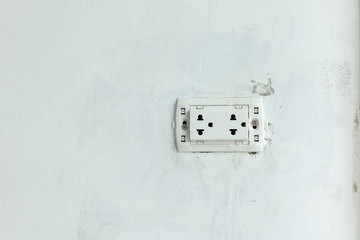 The electric socket with no cover plate on unfinish wall at construction site