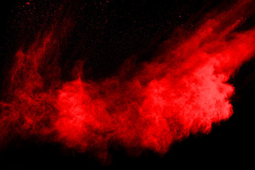 abstract red powder explosion on black background.abstract red powder splatted on black background. Freeze motion of red powder exploding.