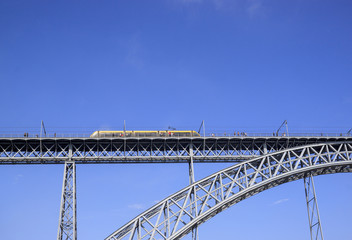Train rides on Dom Luis I Bridge over the river Douro, Porto, Portugal.