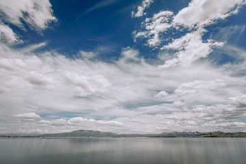 Mountain Lake . Blue sky background with clouds