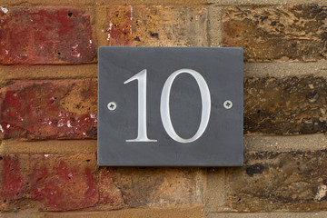 House Number 10 written in white on grey slate