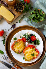 Stuffed peppers with turkey meat and cheese on a light stone background. Healthy food.