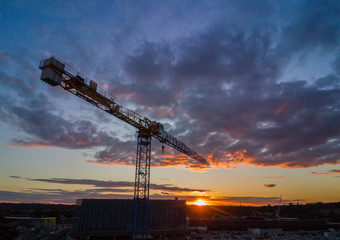 Silhouette crane construction tower at sunset