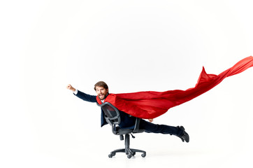 business man riding a chair in a red cloak