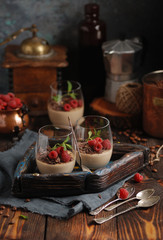 Homemade Italian traditional dessert - coffee panna cotta with nuts, chocolate, strawberry and...