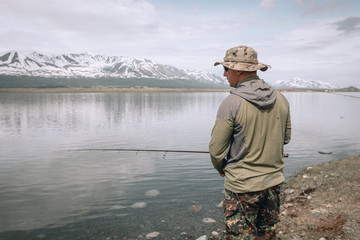 Fototapeta premium Fishing on the mountain river. Trout fishing. Fisherman fishing in the mountains