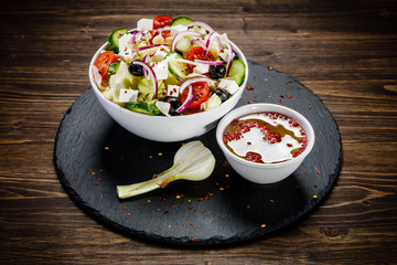 Greek salad on wooden background