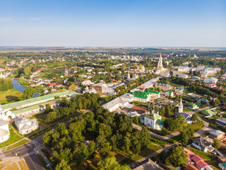 Fototapeta na wymiar Beautiful panoramic view of Suzdal in summer at sunrise. Resurrection Church on the market square in Suzdal. Suzdal is a famous tourist attraction and part of the Golden Ring of Russia