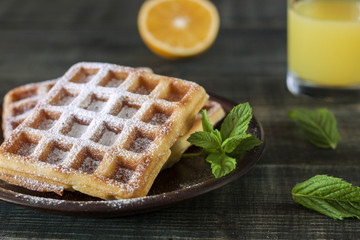 Viennese, Belgian waffles with honey on a white plate.