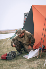 A fisherman selects the right Accessories that he is going to fish with. fishing tackles and fishing gear on on the ground