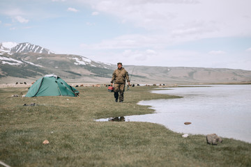 Fototapeta premium A fisherman selects the right Accessories that he is going to fish with. fishing tackles and fishing gear on in the hands