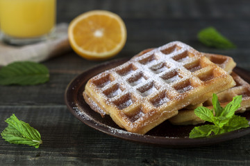 Viennese, Belgian waffles with honey on a white plate.