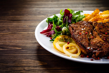 Grilled beefsteak with french fries and vegetable salad