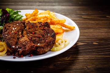 Grilled beefsteak with french fries and vegetable salad