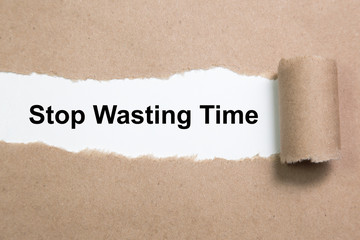 Stop Wasting Time text on paper. Word Stop Wasting Time on torn paper. Concept Image.