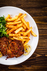 Grilled beefsteak with french fries and vegetable salad