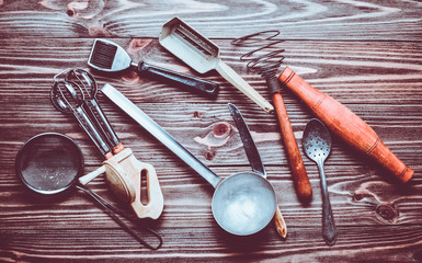 A set of old kitchen tools and cutlery on a wooden table. Vintage cooking in the kitchen. Top view.