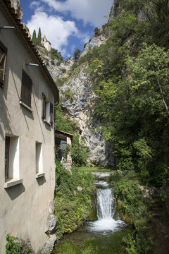 The tenth century village of Moustiers-Sainte-Marie showing a waterfall and the chapel of Notre-Dame-de-Beauvoir