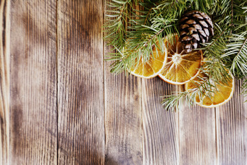 fir tree branches with pine cones and dried oranges Christmas and new year background