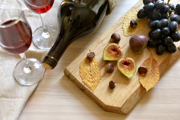 the wine, the figs, the grapes on the table top view