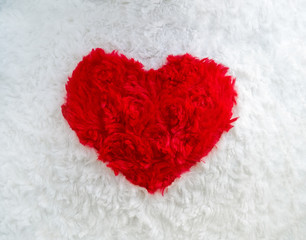 red heart on a white plush fabric - a symbol of love