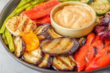 Grilled vegetables on a plate with sauce