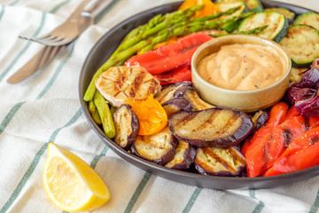 Grilled vegetables on a plate with sauce