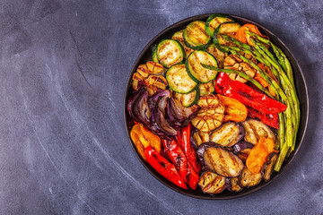 Grilled vegetables on a plate with sauce.