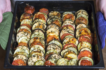 ratatouille vegetarian dish, baked vegetables on a baking tray