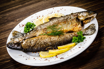 Fish dish - fried fish fillet on wooden table