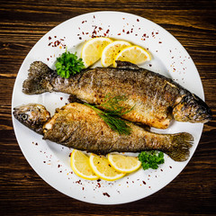 Fish dish - fried fish fillet on wooden table