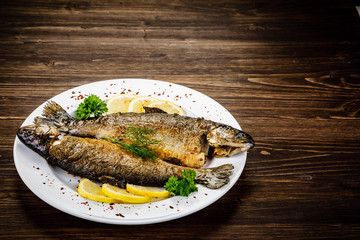 Fish dish - fried fish fillet on wooden table
