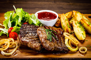 Grilled beefsteak with baked potatoes and vegetables