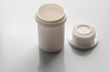 white jar for tablets, capsule on a jar