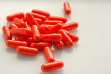 red capsules scattered on the table