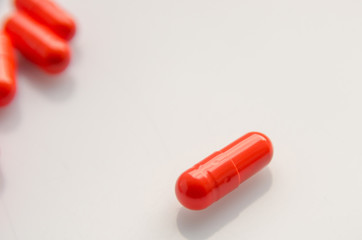 red capsules scattered on the table