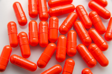 red capsules scattered on the table