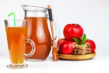 Fresh apple juice in a glass. Fruit harvest. Healthy beverage. Apples on the kitchen table. Production of juice. On a white background.