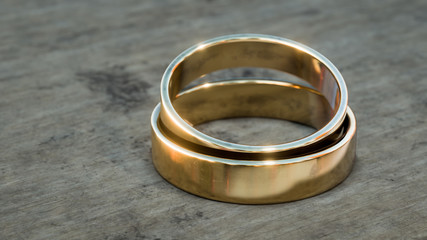 Obraz na płótnie Canvas Gold wedding rings on wooden table 3d illustration