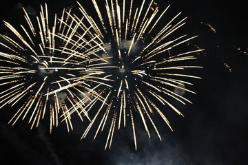 Fireworks. Salute. Sky background Amazing agony of bright yellow shiny lights in the night sky...