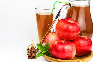 Fresh apple juice in a glass. Fruit harvest. Healthy beverage. Apples on the kitchen table. Production of juice. On a white background.